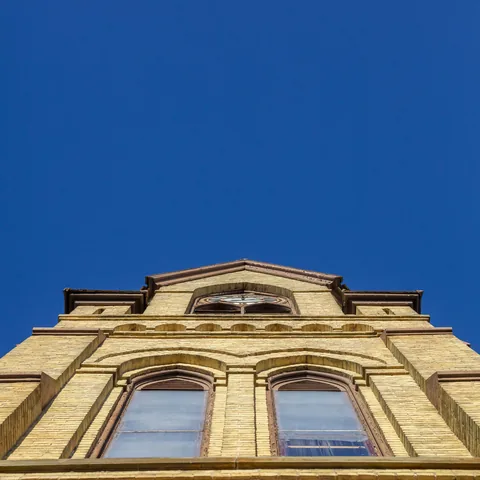 Gothic windows and brickwork viewed from below
