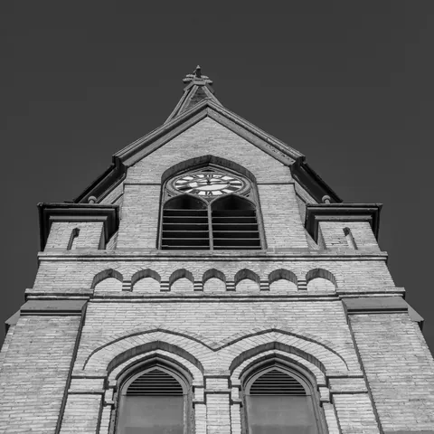 Black and white view looking up the church clock tower