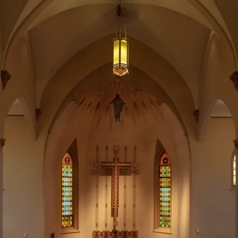 Sanctuary altar beneath the vaulted ceiling and hanging lanterns