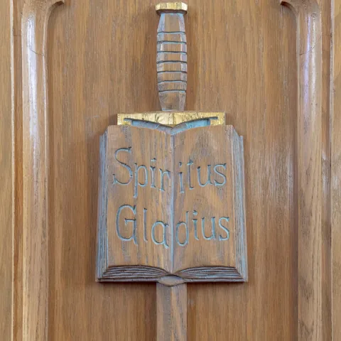 Carved wooden book and sword detail