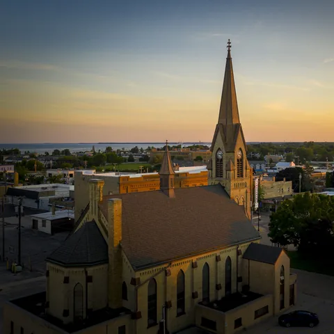 Aerial view of the church roof and spire at sunset