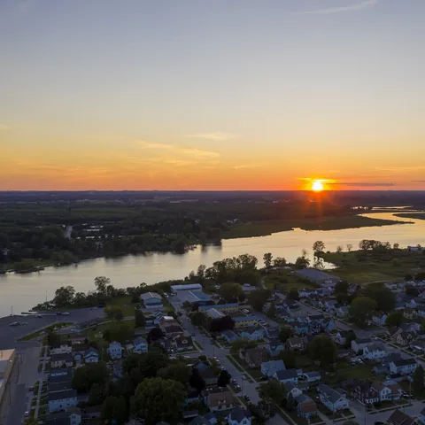 Sun setting over the river and surrounding neighborhood