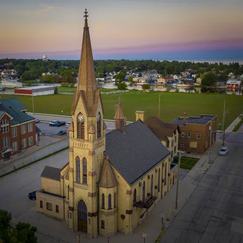 Aerial view of the church clock tower and surrounding neighborhood at dusk