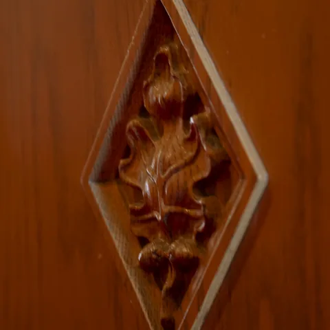 Decorative floral carving in a wooden panel