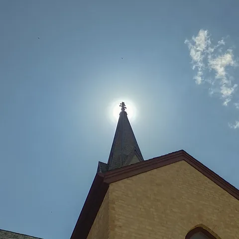 Sunlight behind the church spire